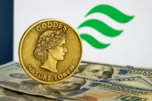 Goddess Nature Token coin on US dollar bills with green logo in background, representing carbon credit tokenisation and blockchain.