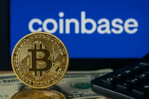 Gold bitcoin in front of Coinbase logo on screen, illustrating Coinbase acquisition activity in the crypto market
