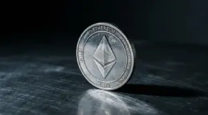 Ethereum coin standing alone on dark surface with dramatic lighting