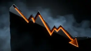 Descending financial chart carved in black stone with amber lighting showing downward market trend