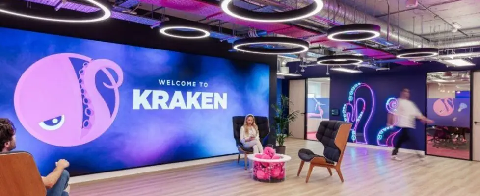 Modern office space of Kraken cryptocurrency exchange with branding and seating.