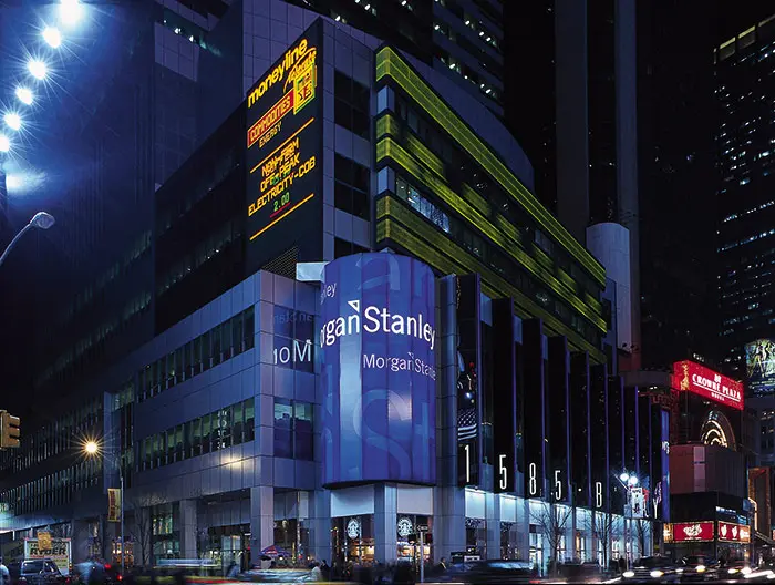 Night view of Morgan Stanley headquarters with illuminated signage.