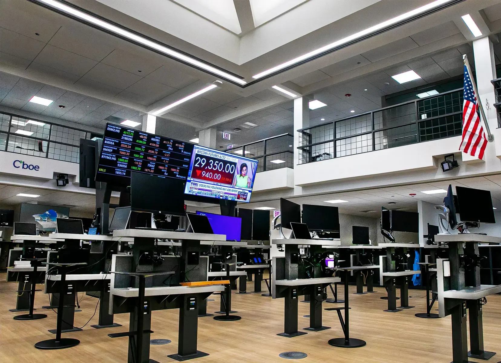 Interior view of the Cboe Global Markets trading floor with computer workstations and financial data displays