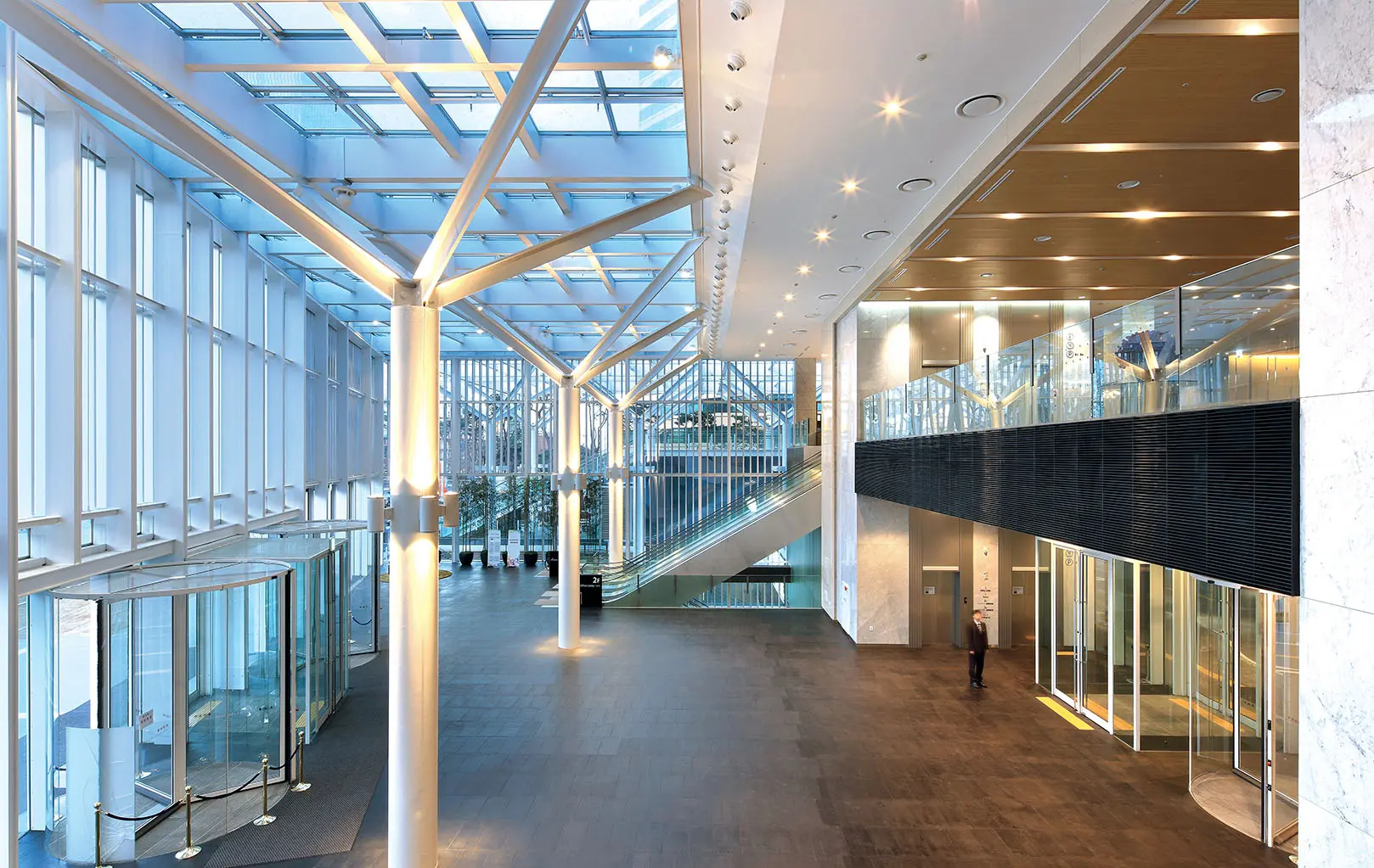Modern glass atrium and lobby of Mirae Asset Center1 in Seoul with high ceilings and structural steel beams