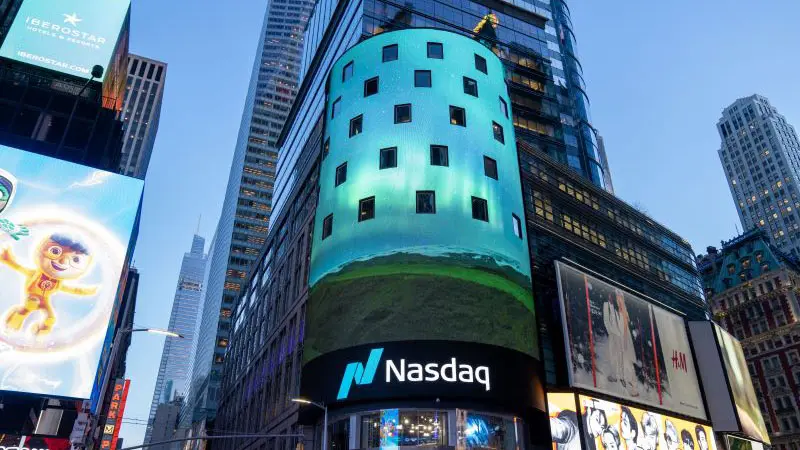 The Nasdaq MarketSite building in Times Square with a large curved digital display screen