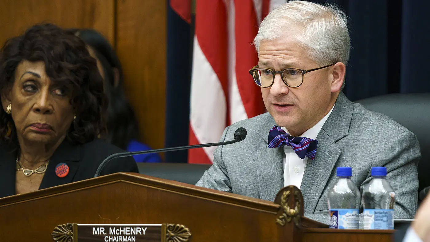 Representative Patrick McHenry speaking at a congressional hearing with a nameplate identifying him as Chairman.