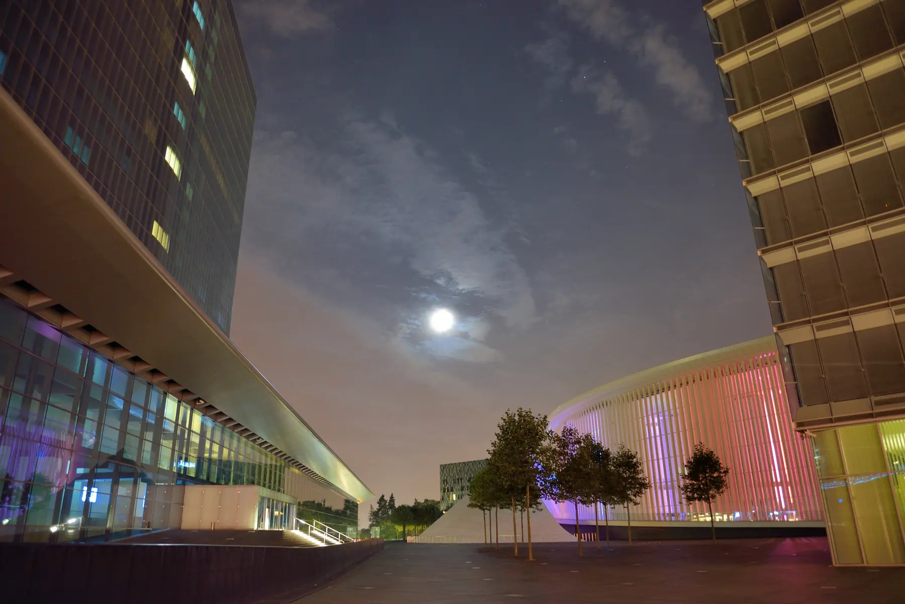 Night view of modern architecture and illuminated buildings at Place de l'Europe in Kirchberg, Luxembourg City.