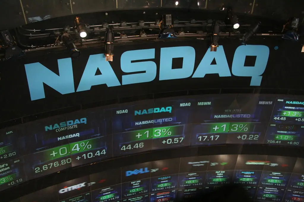 The Nasdaq logo and stock market ticker displays showing financial data.